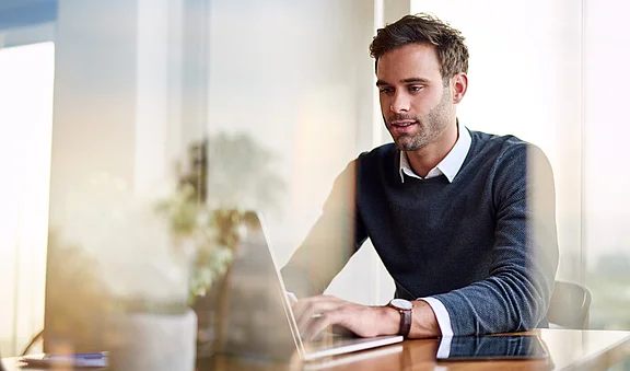 Young businessman using a laptop while working from home